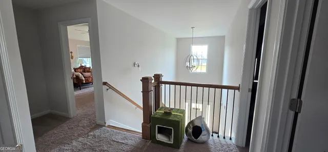 a view of a hallway with seating area