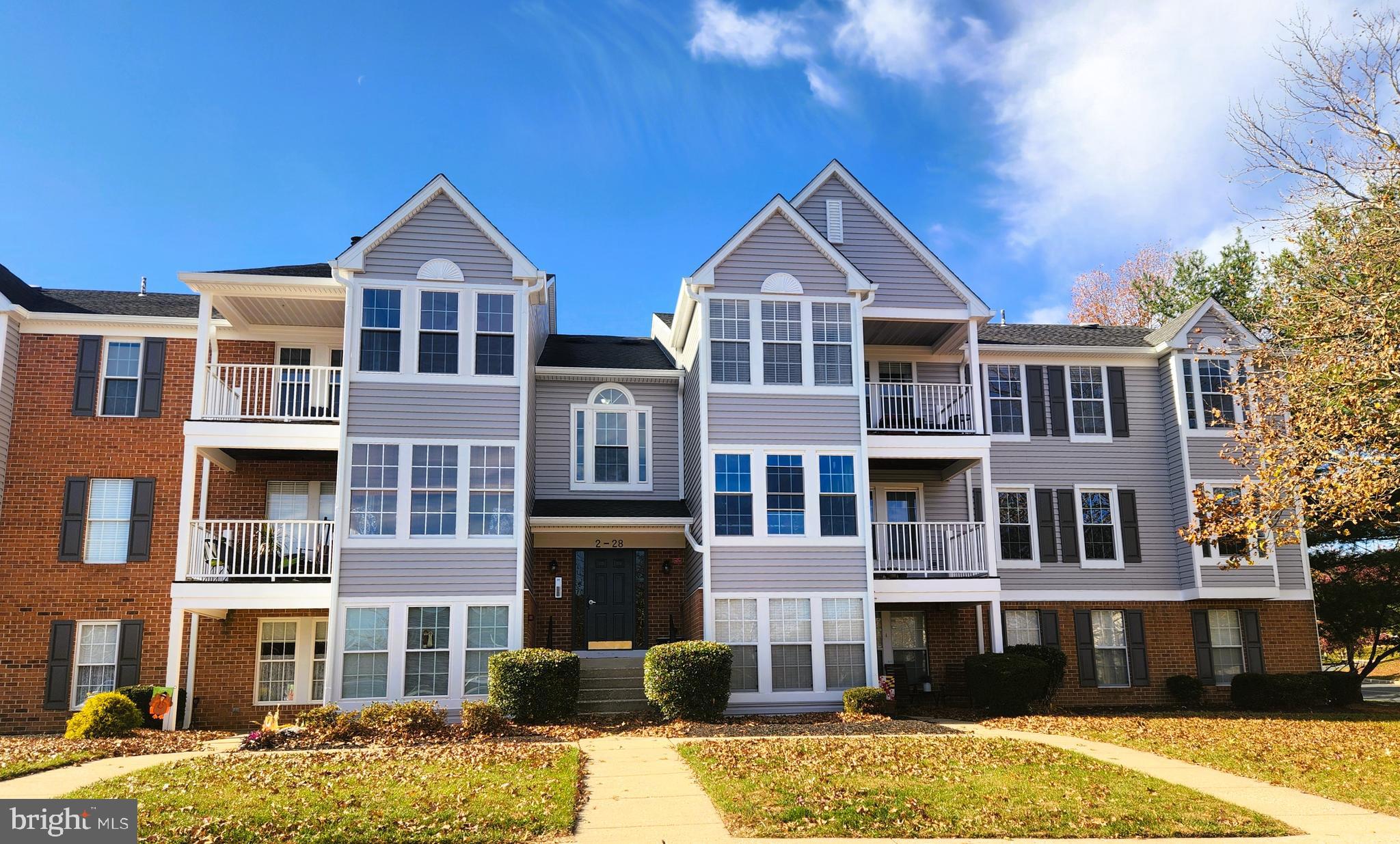 a front view of residential houses with yard