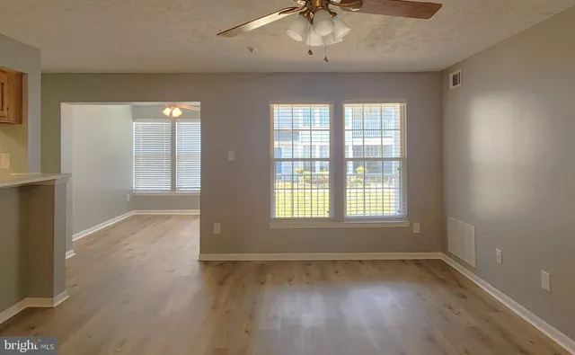 a kitchen with a refrigerator and cabinets
