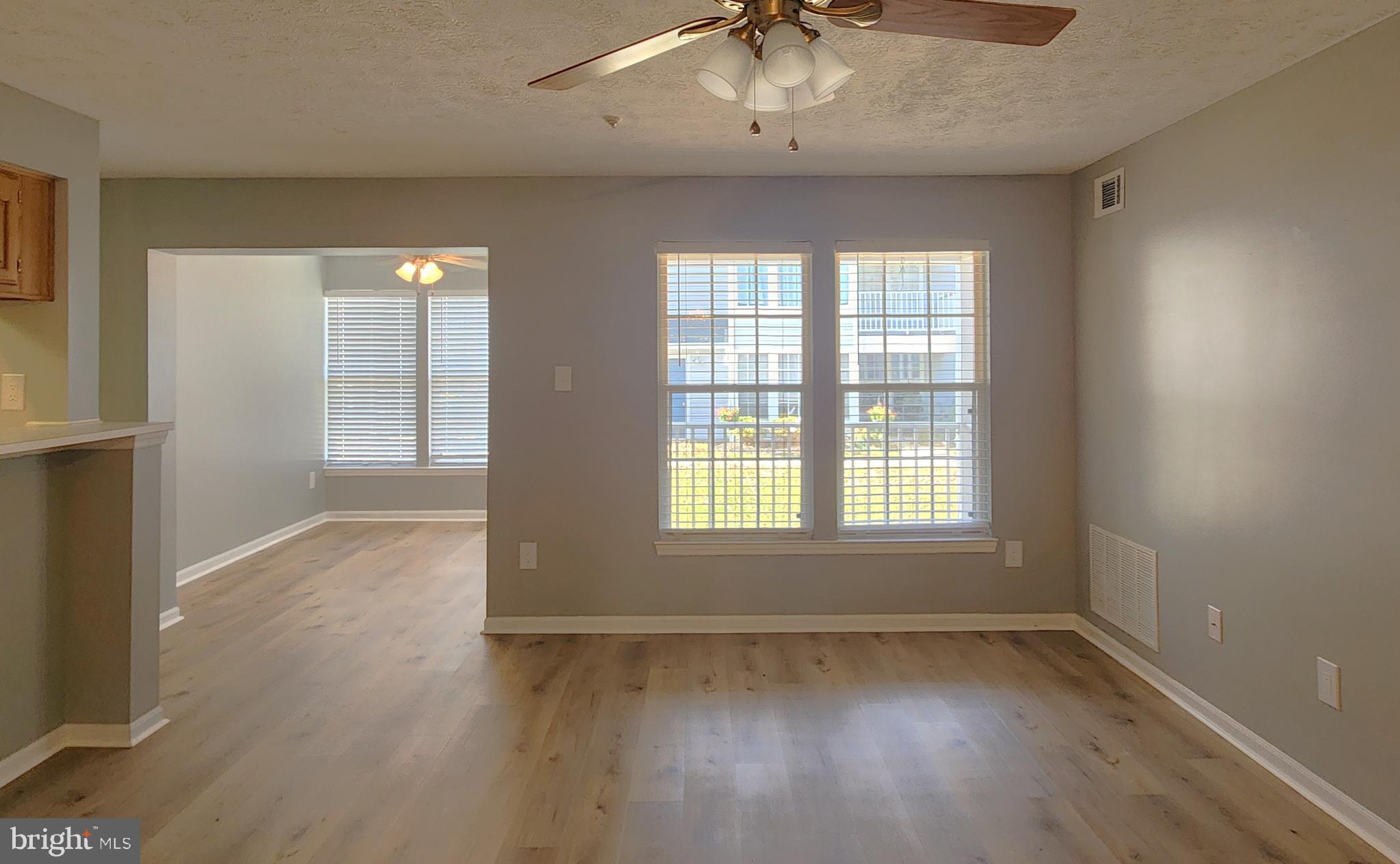 16 Laurel Path Court, Unit 1 Nottingham, MD 21236 - Photo 13 of 23 an empty room with wooden floor and windows
