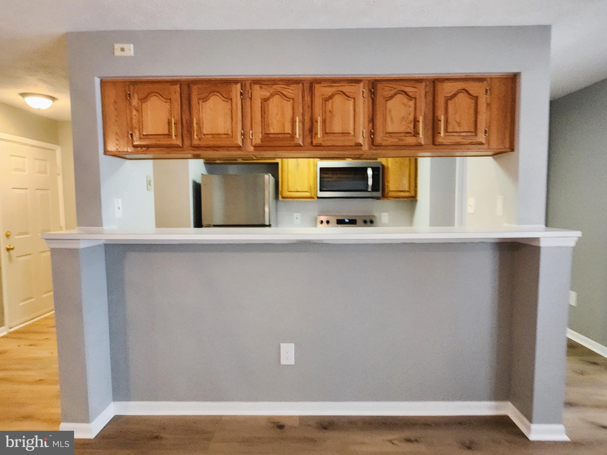 16 Laurel Path Court, Unit 1 Nottingham, MD 21236 - Photo 14 of 23 a kitchen with a refrigerator and cabinets