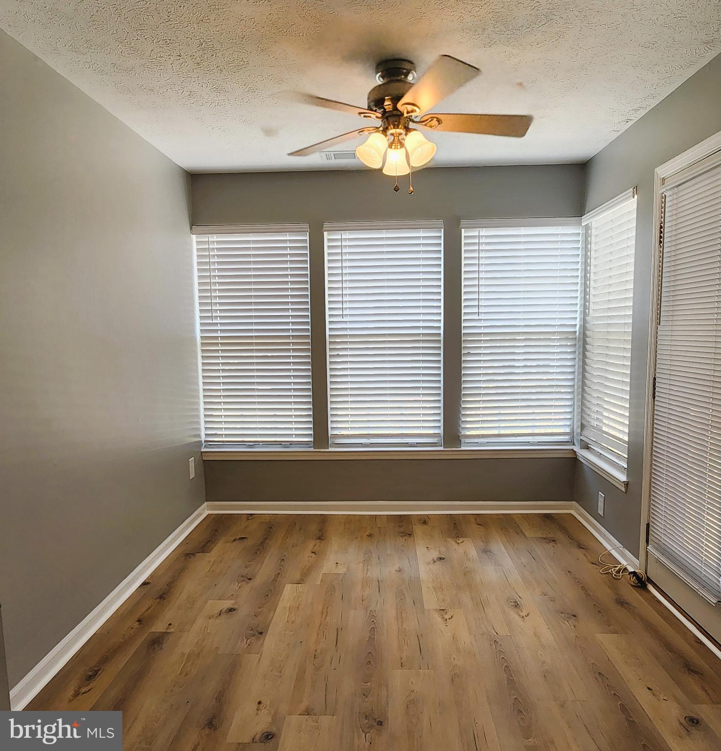 16 Laurel Path Court, Unit 1 Nottingham, MD 21236 - Photo 15 of 23 a view of wooden floor and a chandelier fan in a room