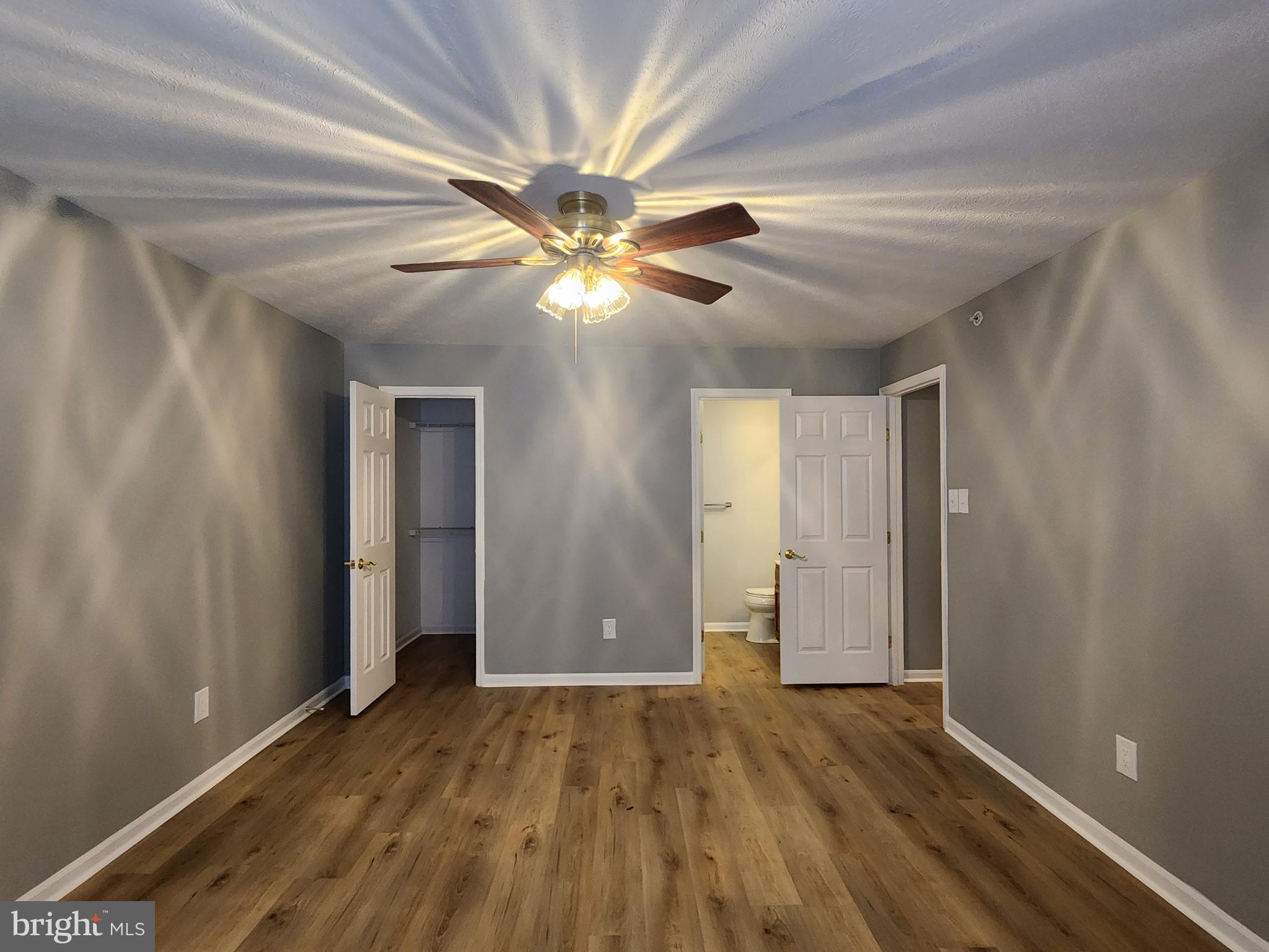 16 Laurel Path Court, Unit 1 Nottingham, MD 21236 - Photo 19 of 23 a view of an empty room with window and wooden floor