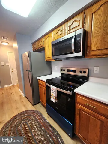 a kitchen with stainless steel appliances granite countertop a sink and cabinets