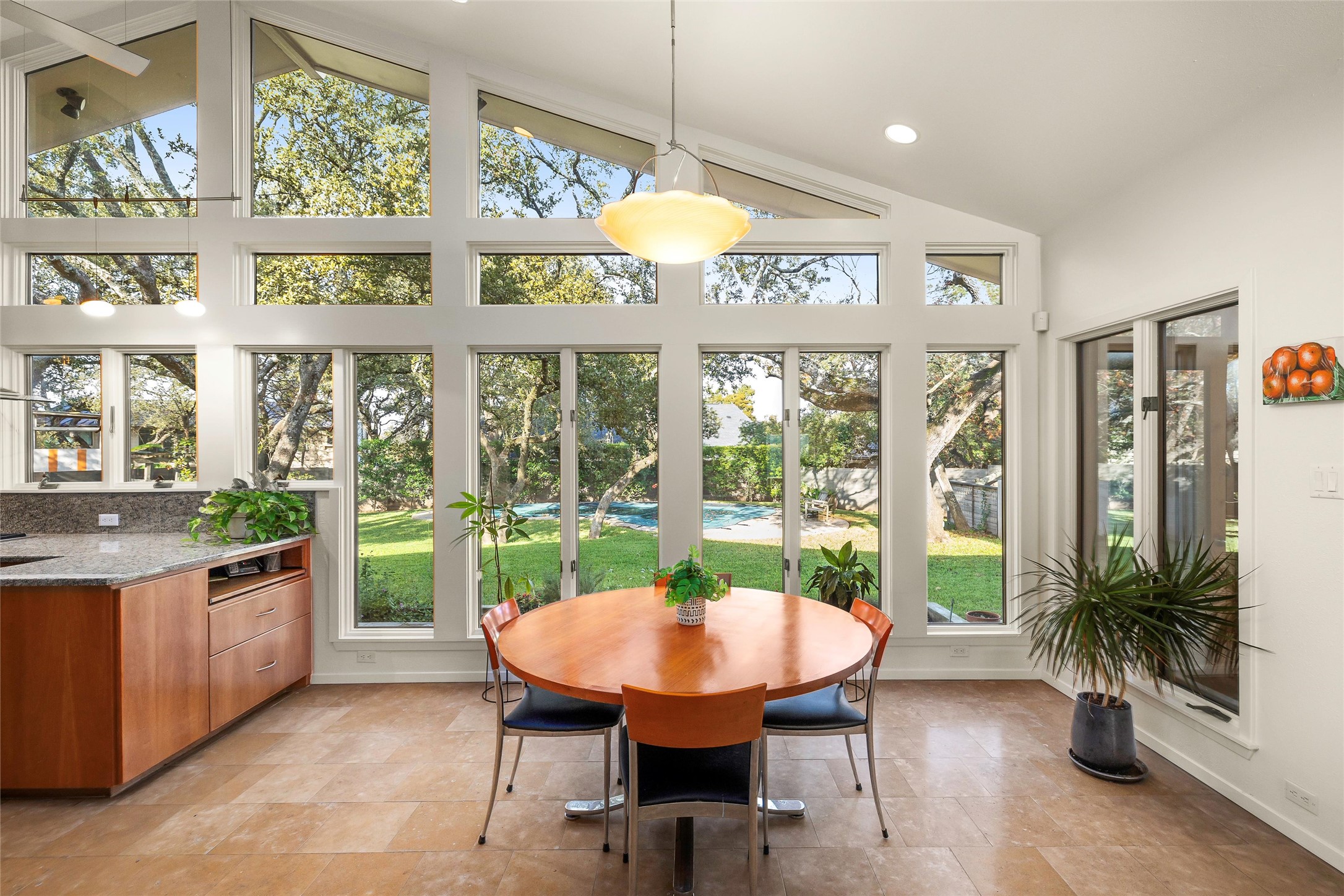 Incredible wall of windows bringing in natural light to your breakfast nook off kitchen and next to screened in patio