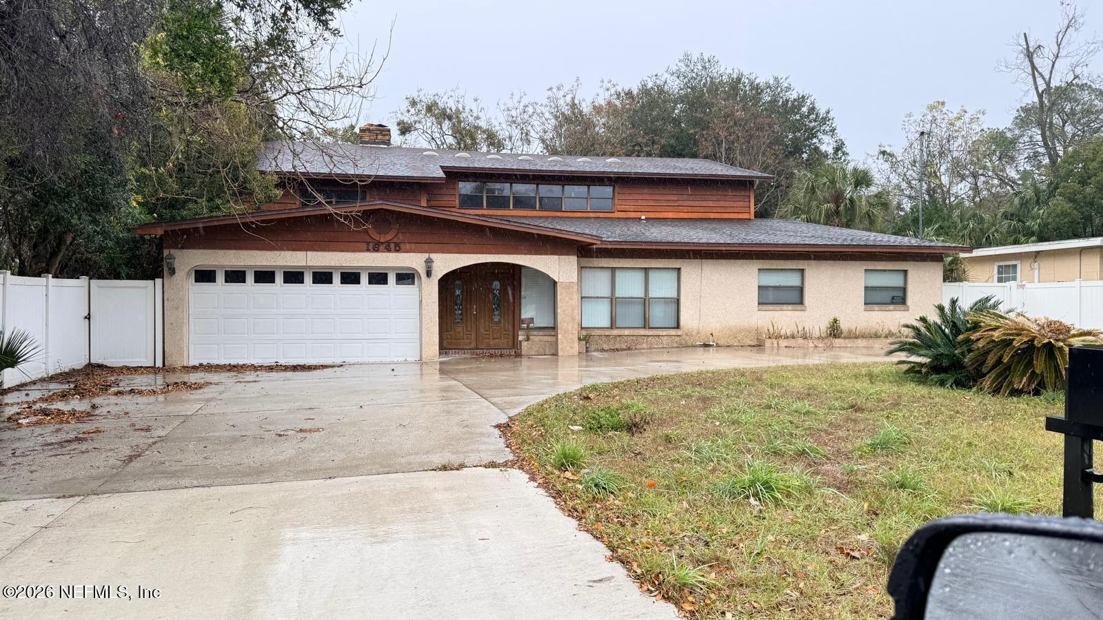 1645 Forest Hills Road Jacksonville, FL 32208 - Photo 2 of 15 a front view of a house with a yard