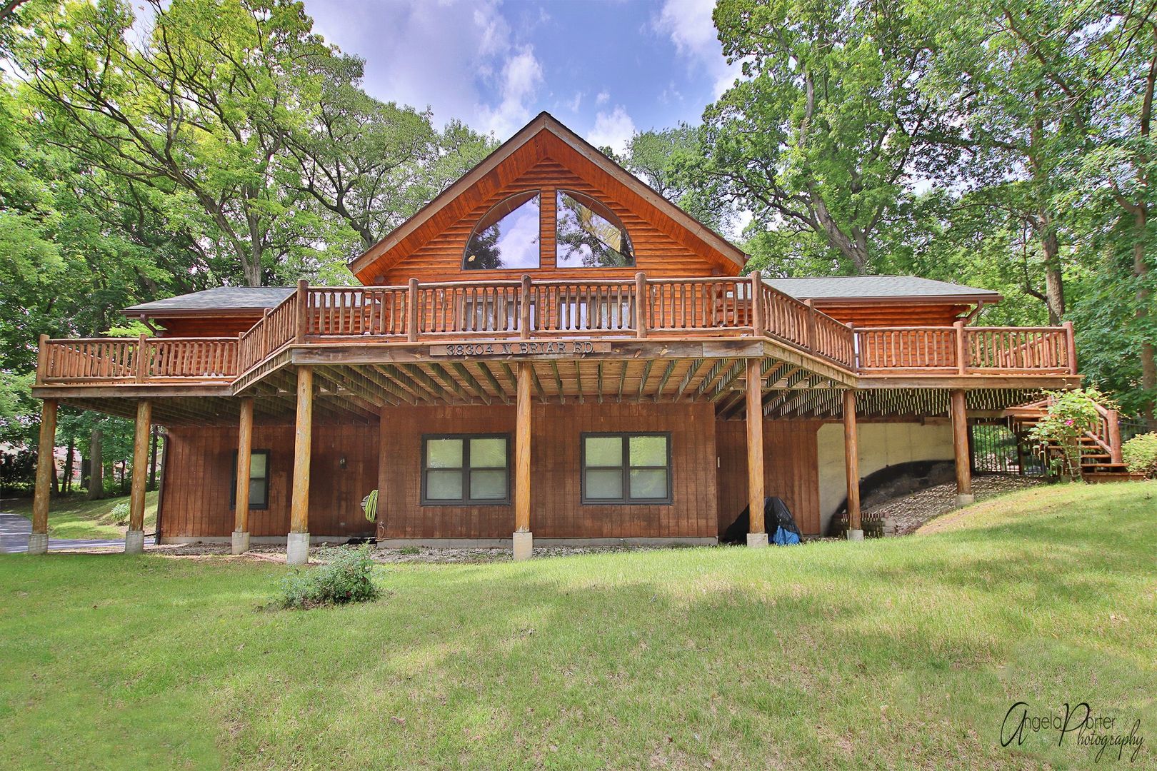 a front view of a house with a garden