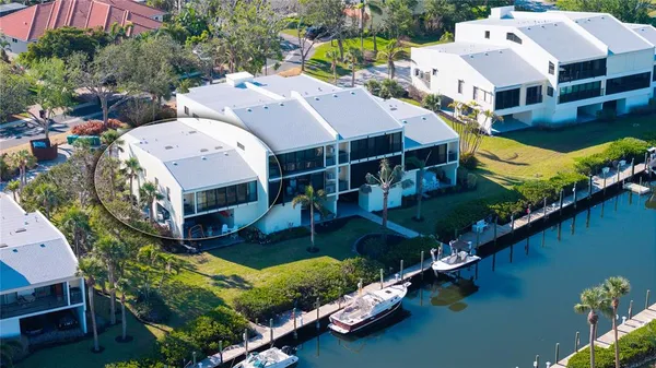 a view of a dry yard with wooden fence