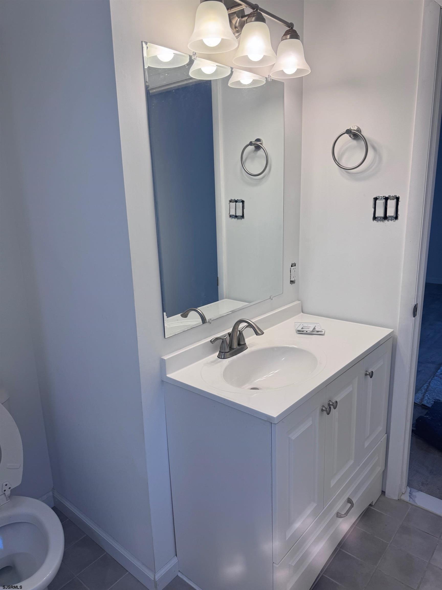 12 Colwick Drive Somers Point, NJ 08244 - Photo 12 of 17 a bathroom with a sink vanity mirror and toilet