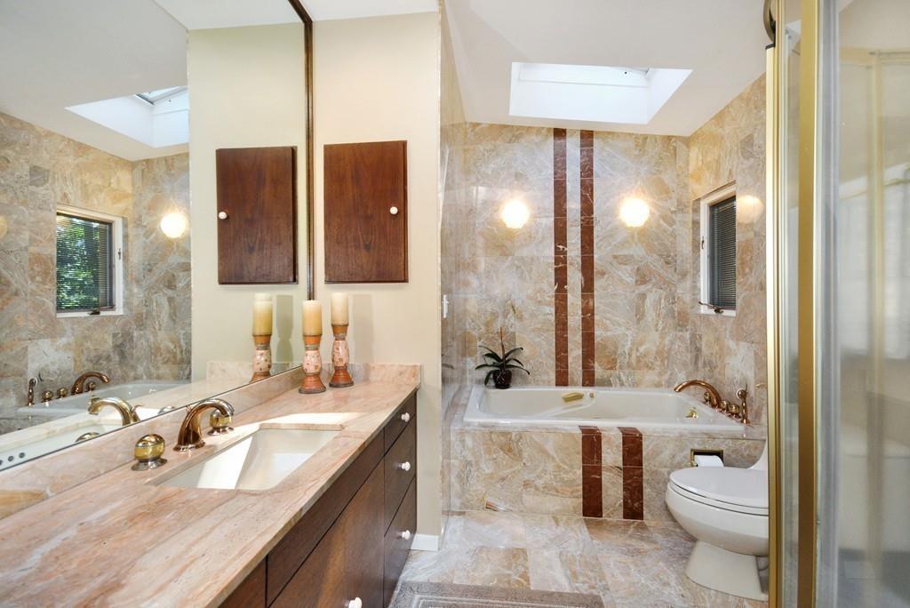 263 Old Concord Road Lincoln, MA 01773 - Photo 20 of 41 a bathroom with a double vanity sink toilet mirror and shower