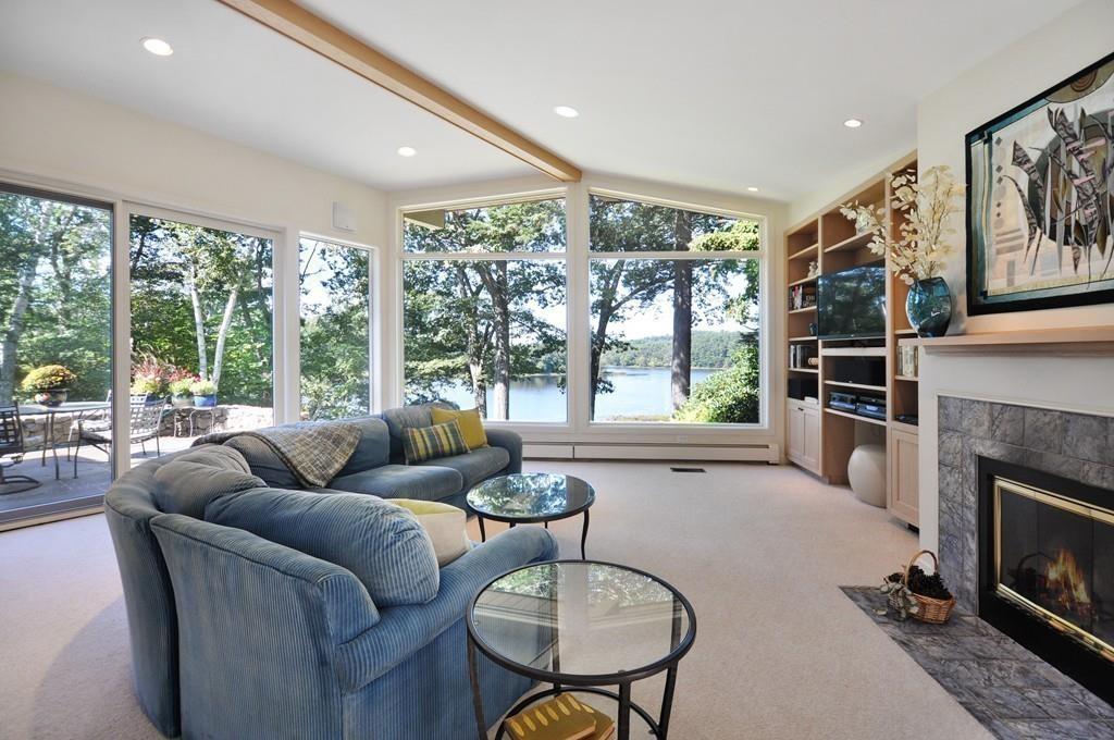 263 Old Concord Road Lincoln, MA 01773 - Photo 8 of 41 a living room with furniture a fireplace and a large window