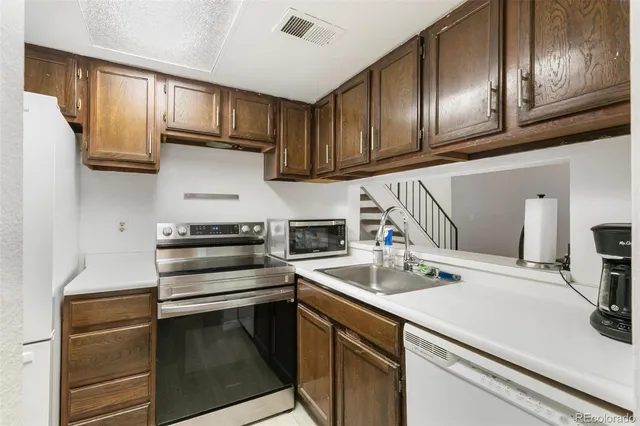 a kitchen with granite countertop stainless steel appliances and cabinets