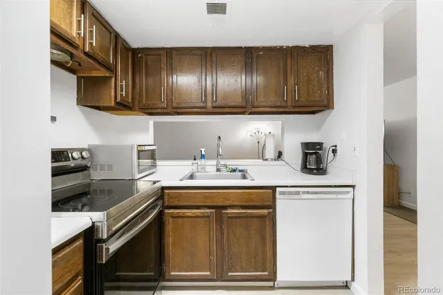 a kitchen with stainless steel appliances granite countertop a sink stove and cabinets