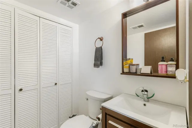 a bathroom with a sink a toilet and mirror