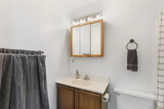 a bathroom with a sink vanity and mirror
