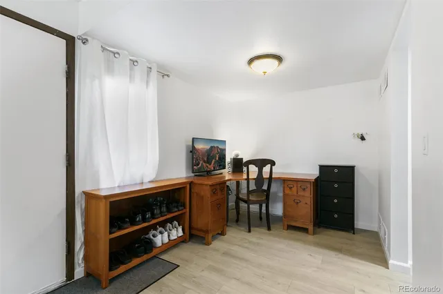 a view of work space with furniture and window