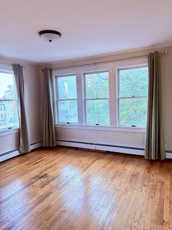 2 Chase Street, Unit 2 Beverly, MA 01915 - Photo 5 of 11 a view of an empty room with wooden floor and a window