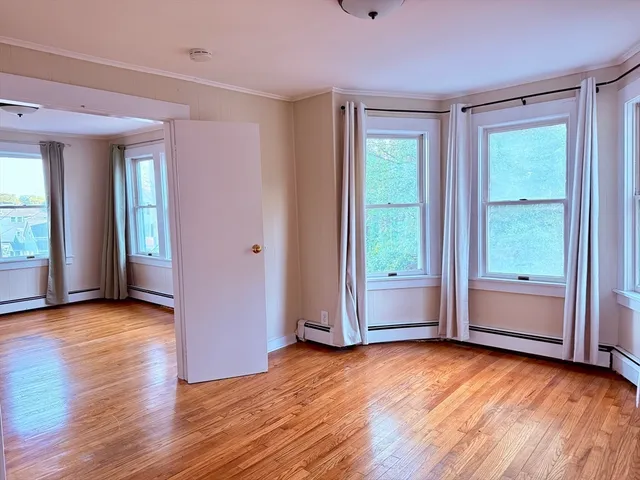a view of room with hardwood floor and window