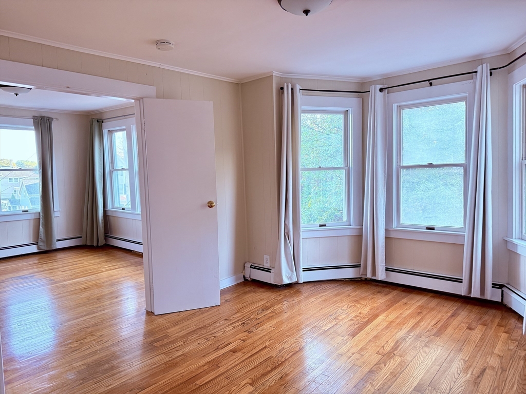 2 Chase Street, Unit 2 Beverly, MA 01915 - Photo 7 of 11 a view of empty room with wooden floor and fan