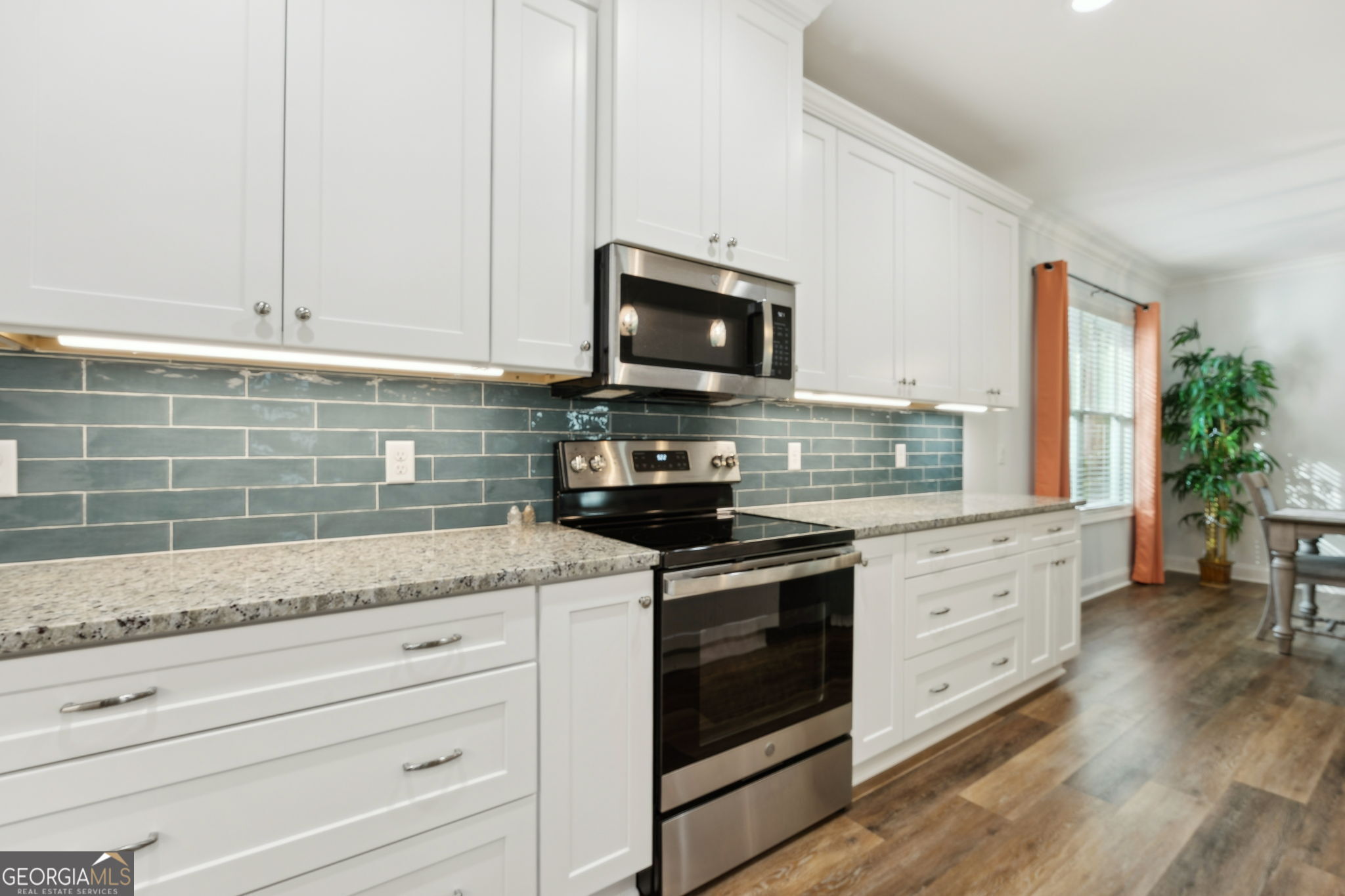 212 Placid Road St. Marys, GA 31558 - Photo 17 of 75 a kitchen with granite countertop cabinets stainless steel appliances and a counter space