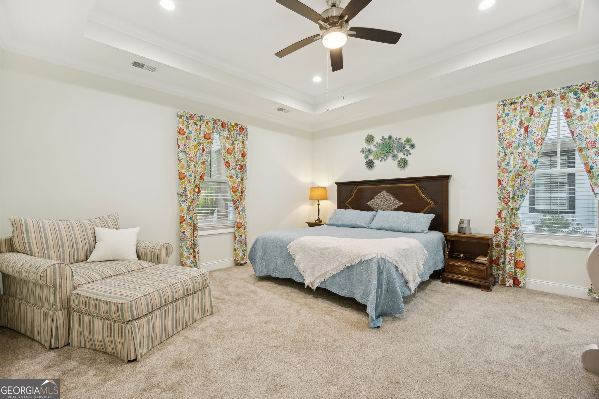 212 Placid Road St. Marys, GA 31558 - Photo 19 of 75 a bedroom with a large bed and a chandelier