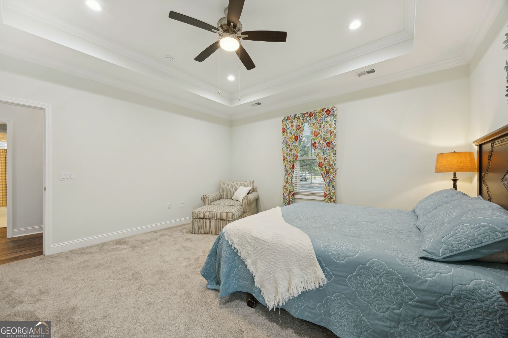 212 Placid Road St. Marys, GA 31558 - Photo 20 of 75 a bedroom with a large bed and a ceiling fan