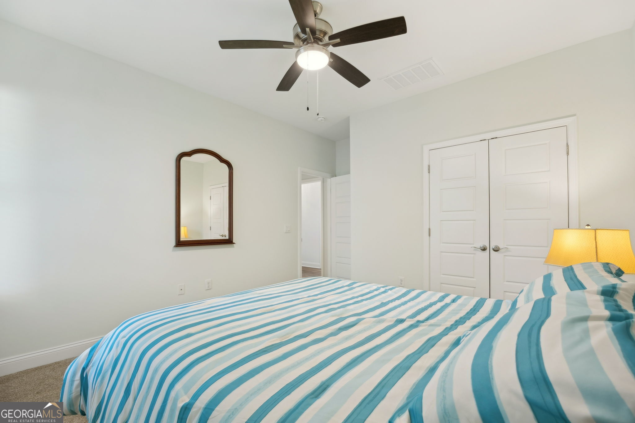 212 Placid Road St. Marys, GA 31558 - Photo 27 of 75 a bedroom with a bed and a chandelier