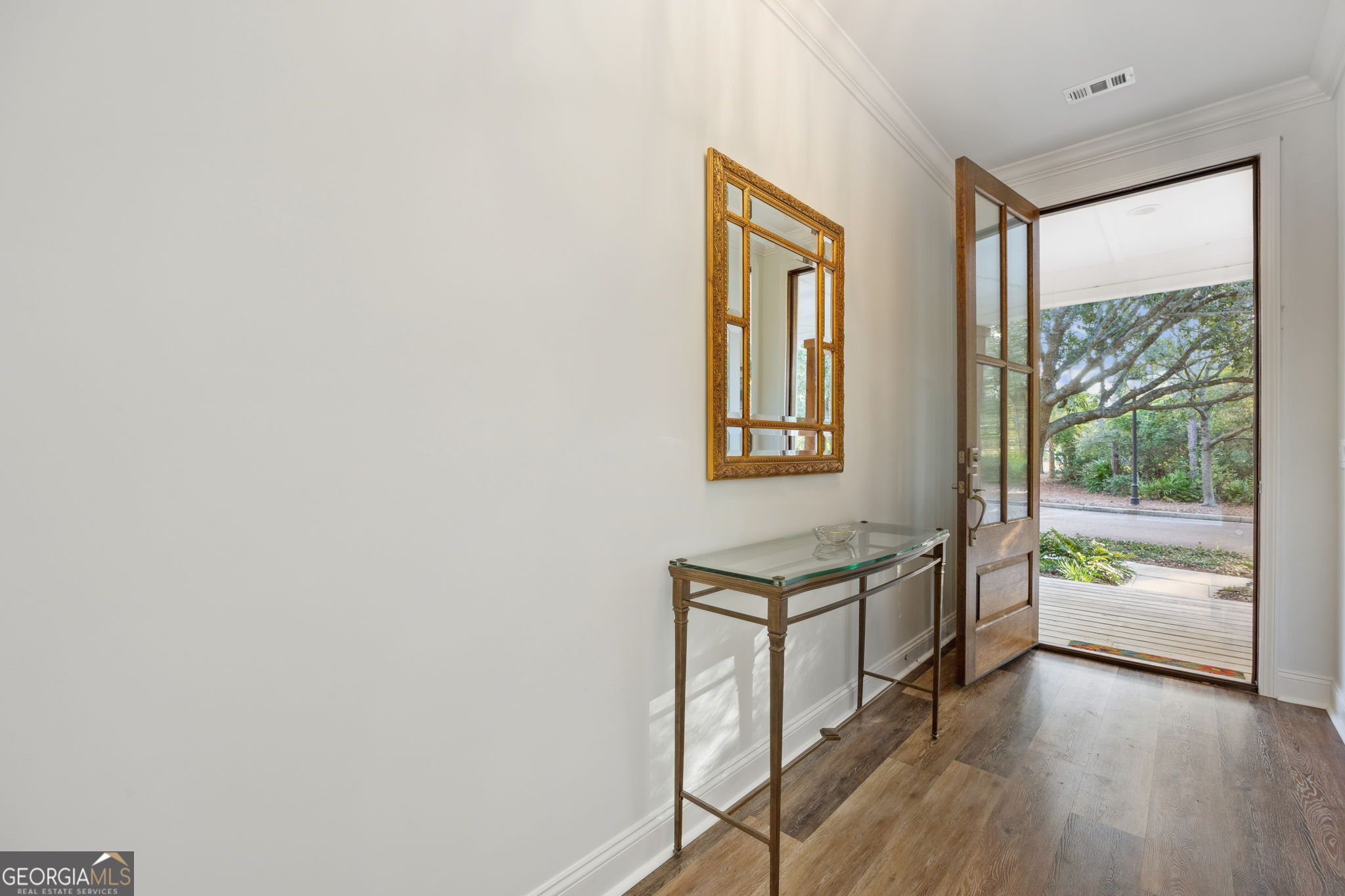212 Placid Road St. Marys, GA 31558 - Photo 6 of 75 a hallway with a wooden floor and a window