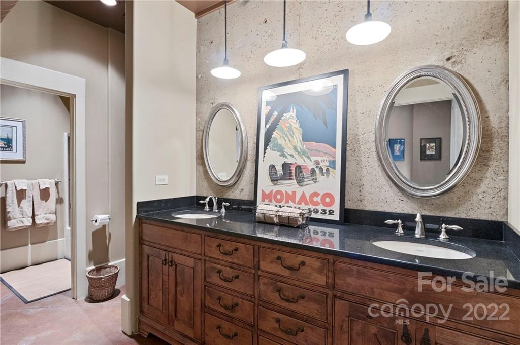 207 Herbert Page Road Tryon, NC 28782 - Photo 33 of 47 a bathroom with a granite countertop double vanity sink and a mirror