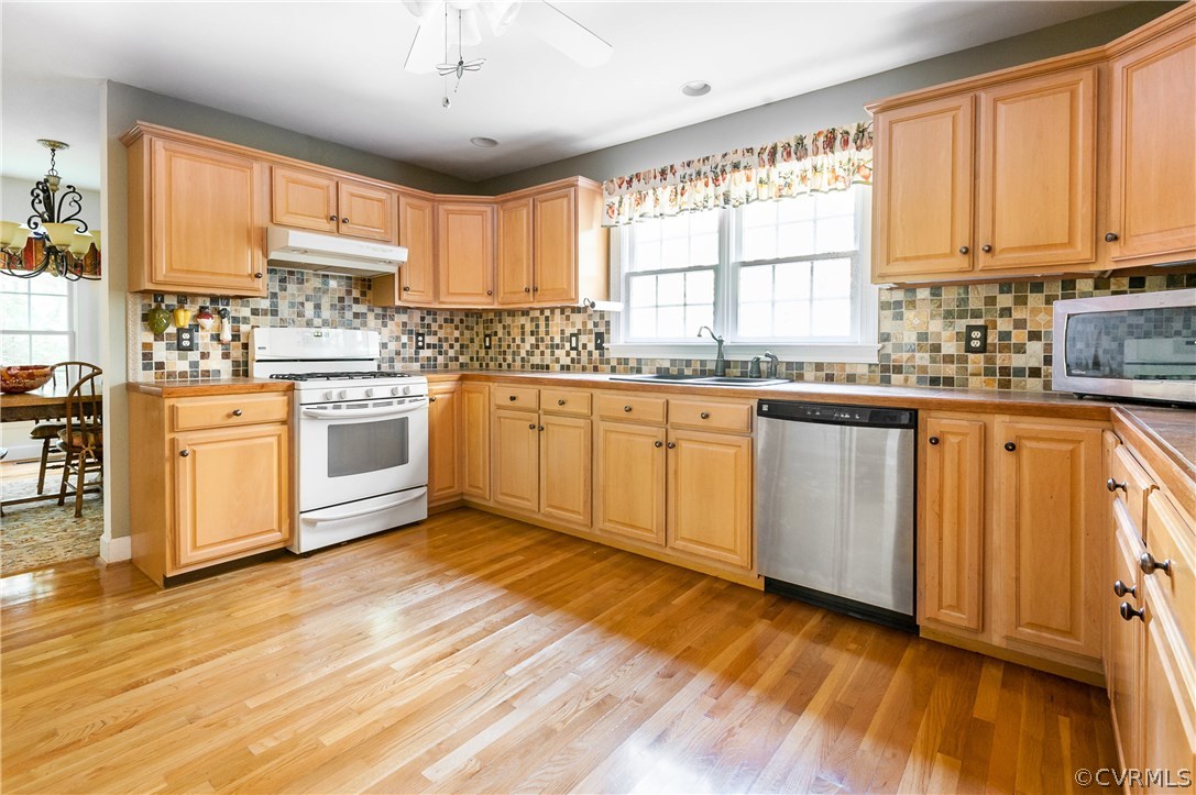 17534 Parsons Ridge Road Beaverdam, VA 23015 - Photo 8 of 34 a kitchen with stainless steel appliances granite countertop wooden cabinets a sink a stove a dining table and chairs