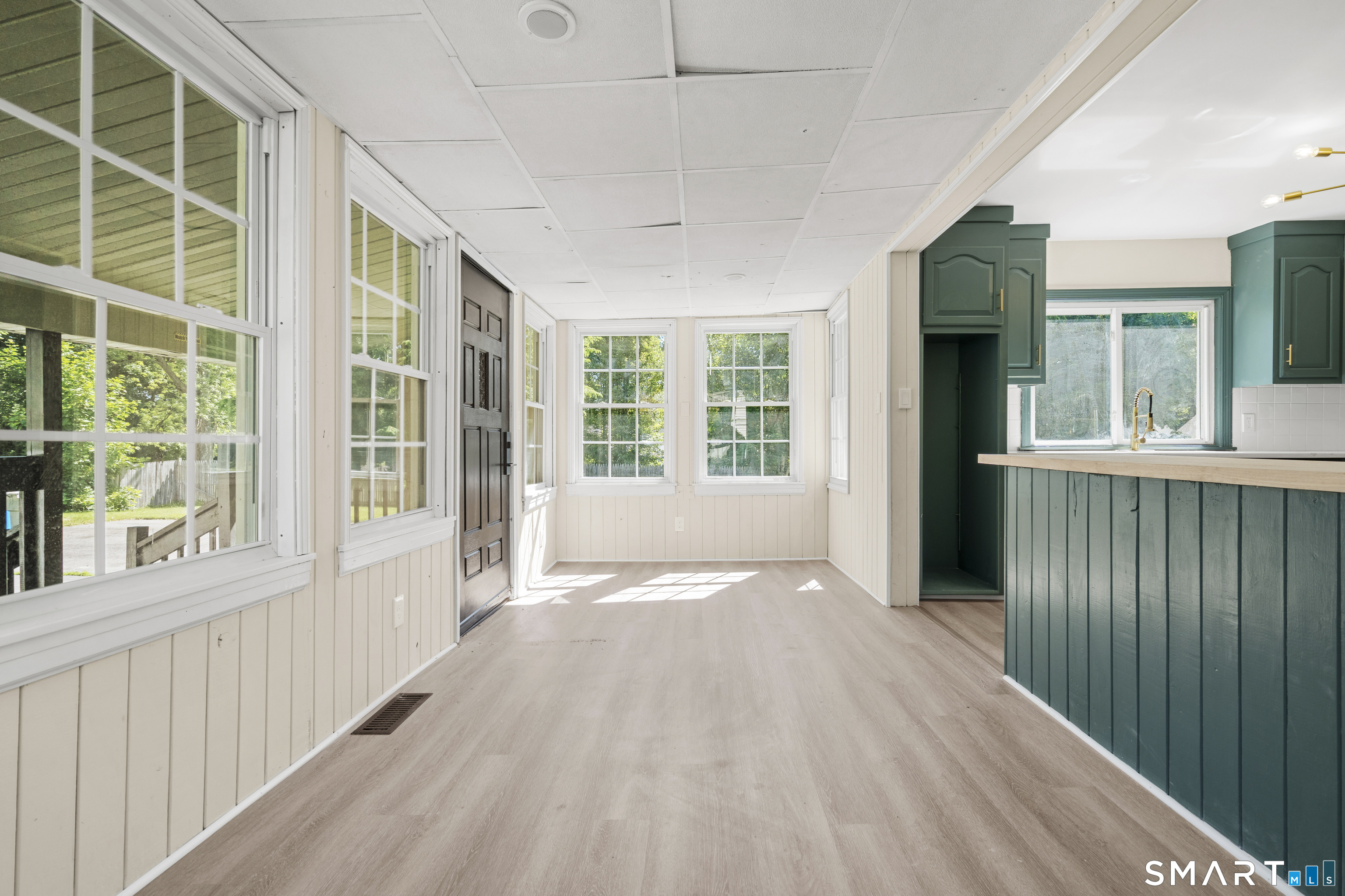 175 Moody Street Bristol, CT 06010 - Photo 15 of 28 a view of an empty room with a window and wooden floor