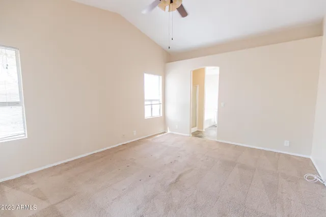 a kitchen with granite countertop white cabinets and a large window