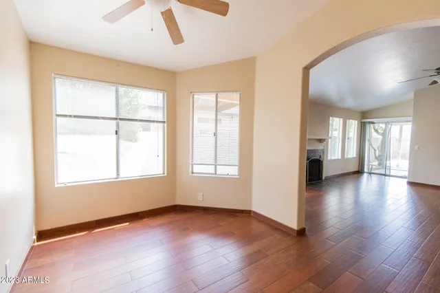 a view of empty room with fireplace and wooden floor