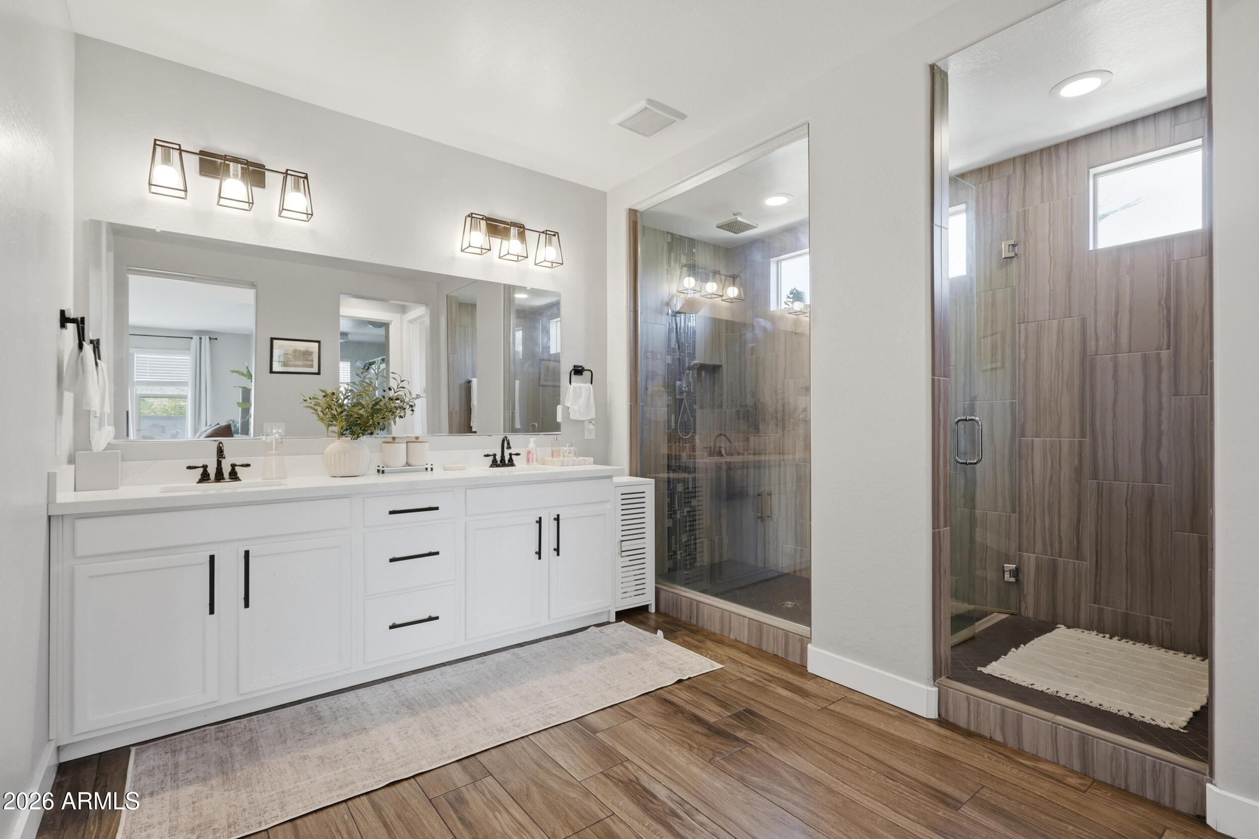 12517 West Lawrence Road Glendale, AZ 85307 - Photo 28 of 52 a spacious bathroom with a shower sink and mirror