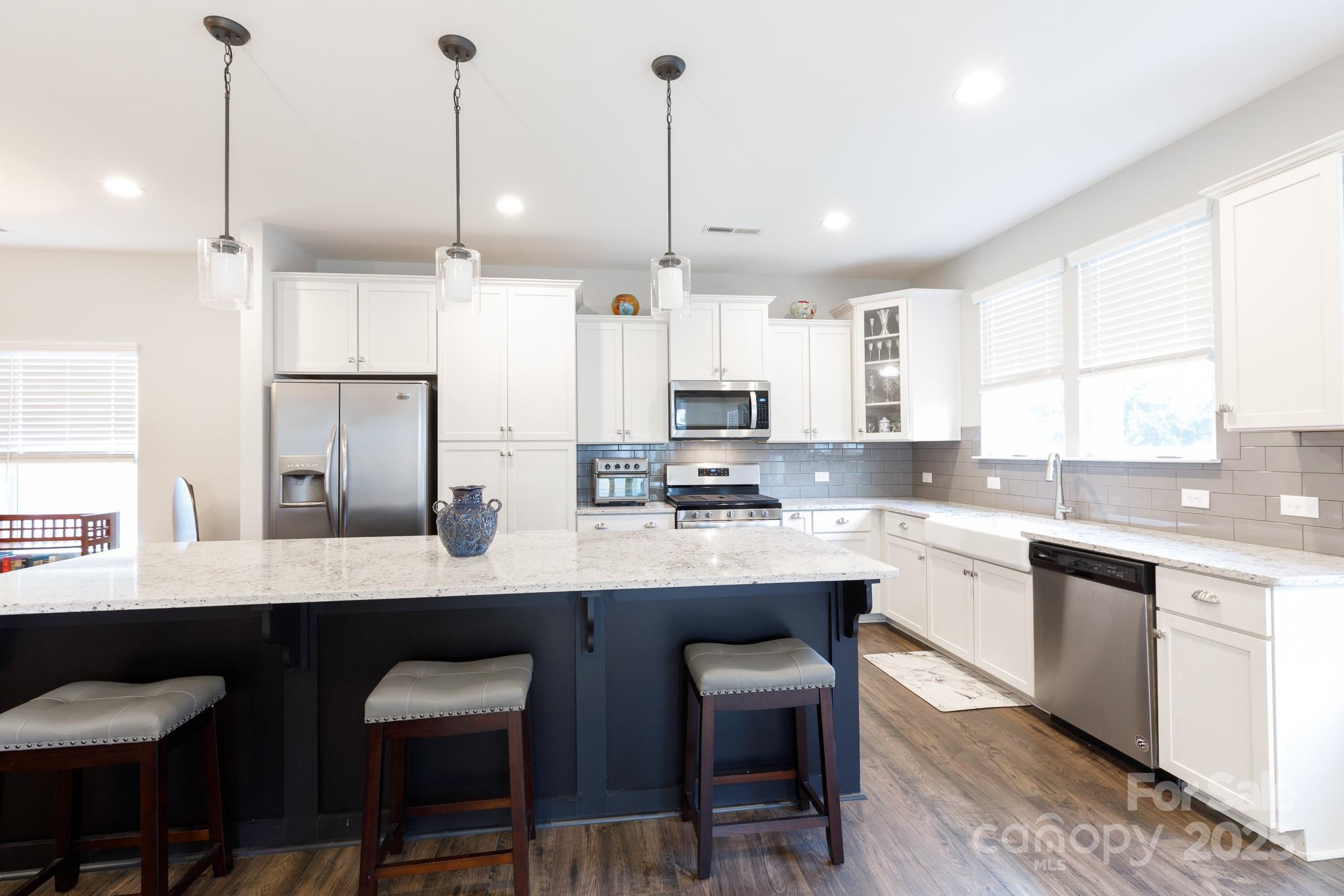50109 Robins Nest Lane Lancaster, SC 29720 - Photo 11 of 45 a kitchen with stainless steel appliances granite countertop a sink a stove a microwave a center island and cabinets