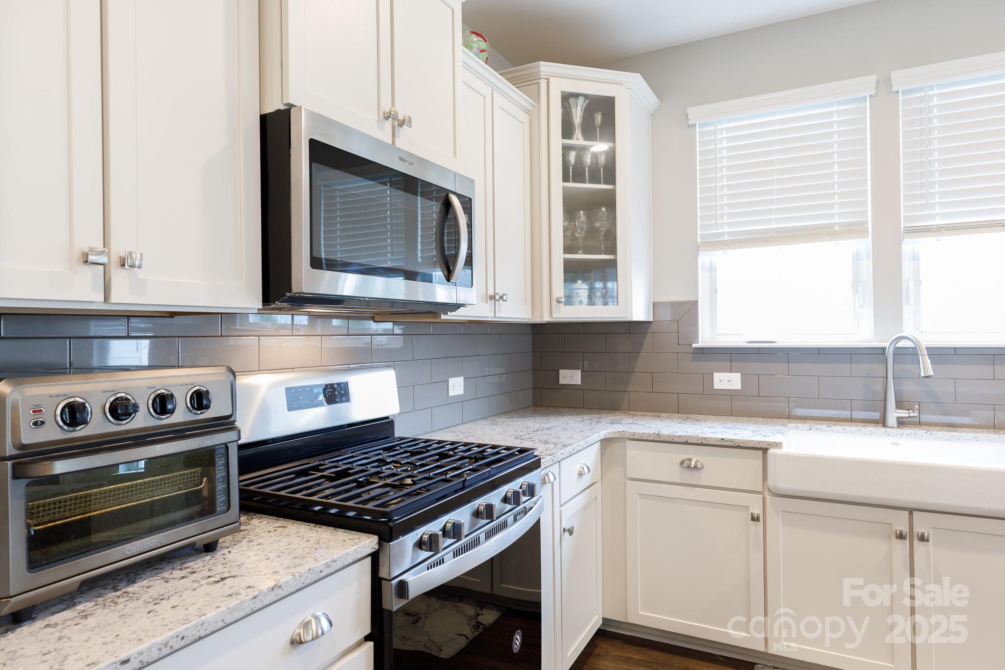 50109 Robins Nest Lane Lancaster, SC 29720 - Photo 14 of 45 a kitchen with granite countertop a stove a sink and a microwave