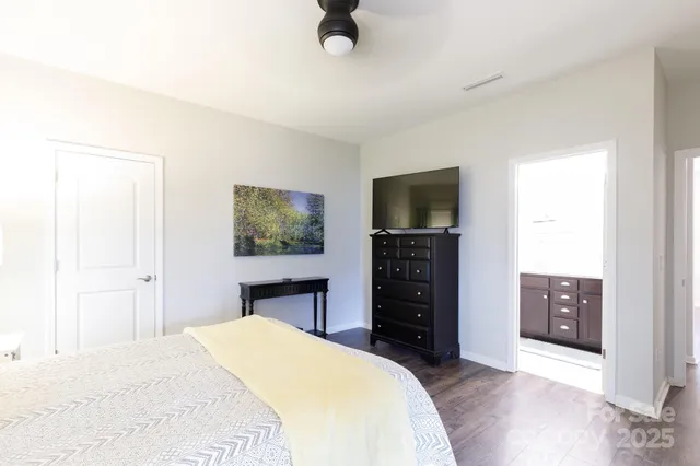 a bedroom with a bed and a television