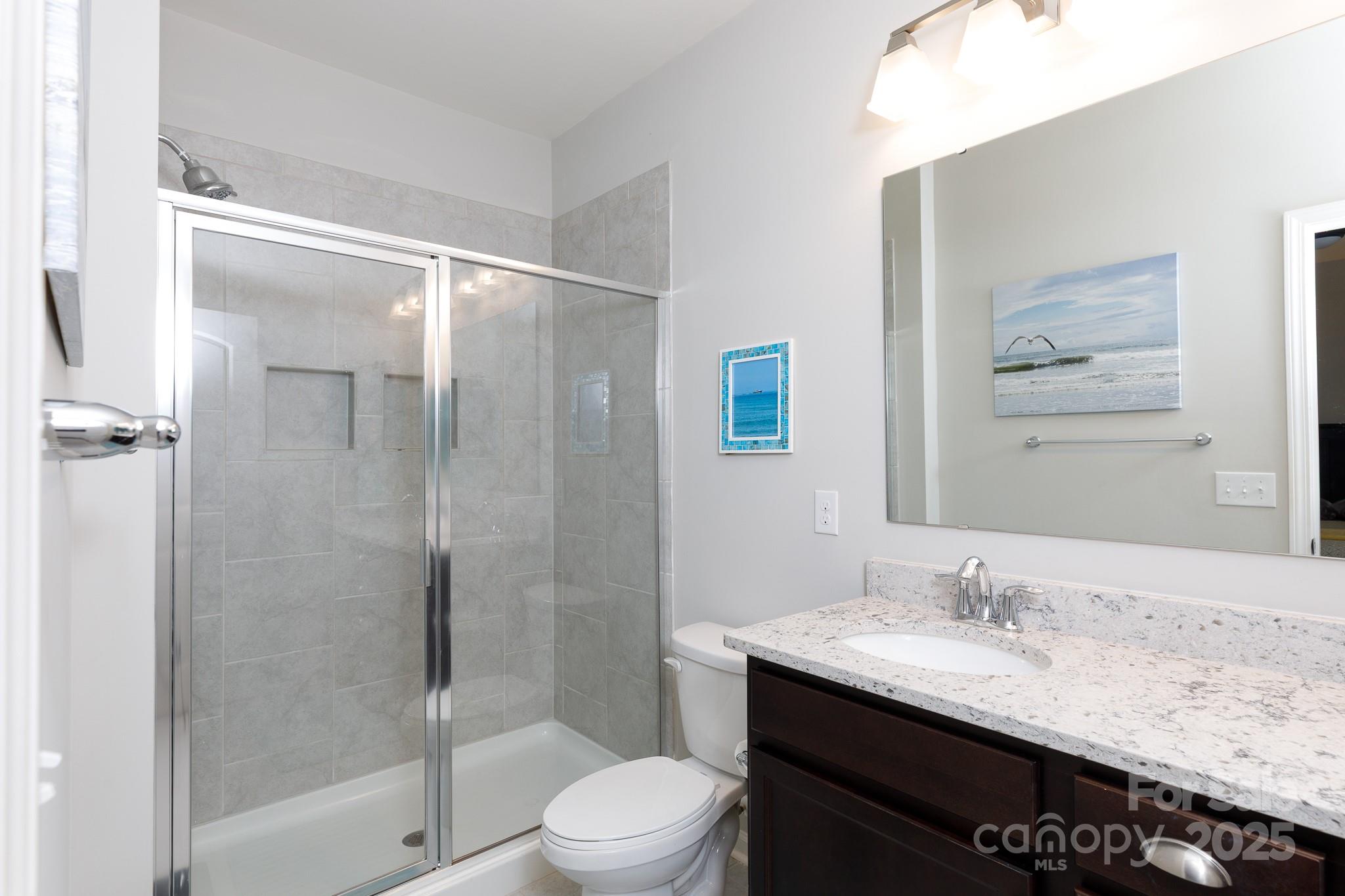50109 Robins Nest Lane Lancaster, SC 29720 - Photo 19 of 45 a bathroom with a granite countertop sink toilet and shower