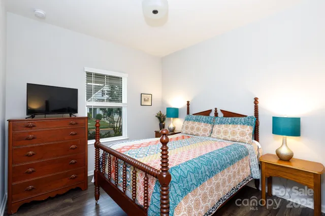 a bedroom with a bed and flat screen tv