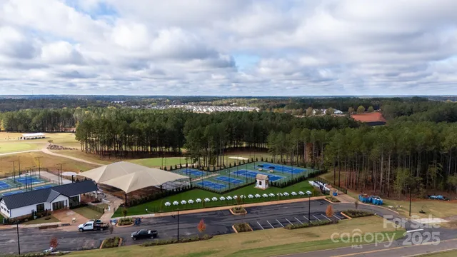 a view of a swimming pool with lawn chairs under an umbrella