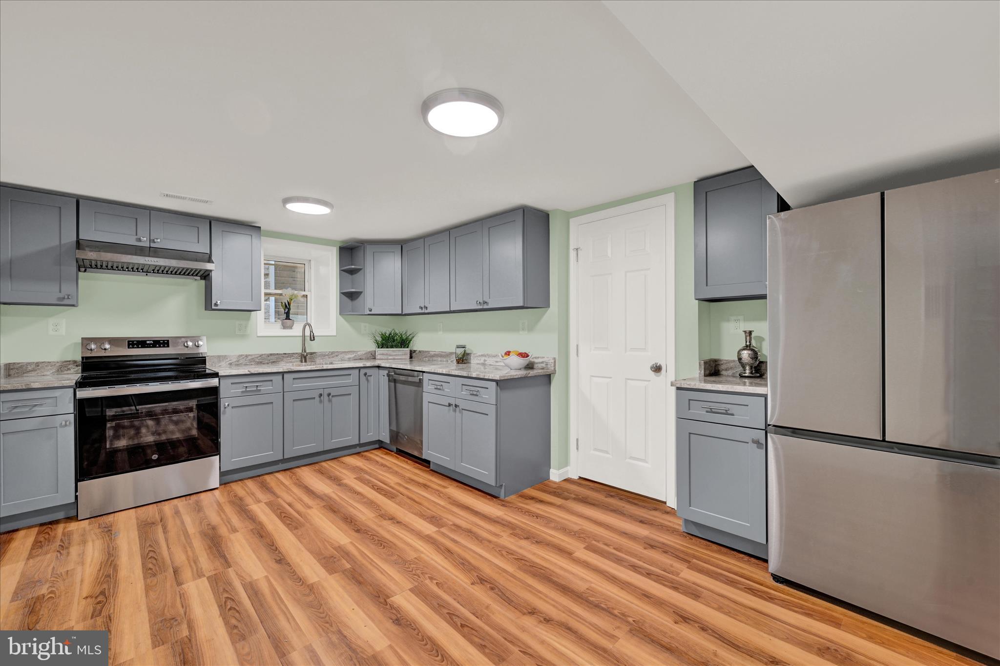 8511 Frederick Road Ellicott City, MD 21043 - Photo 6 of 36 a kitchen with a refrigerator stove and sink