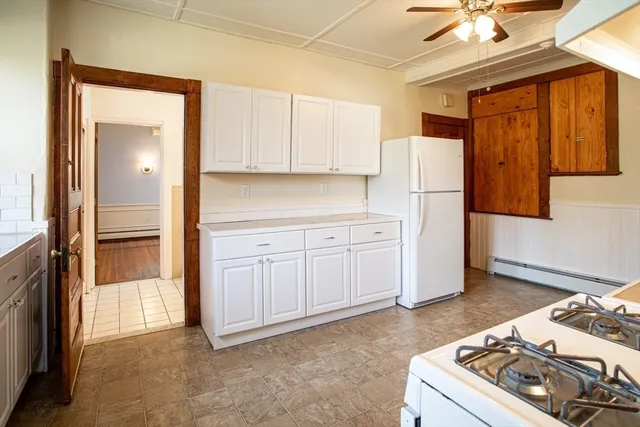 a kitchen with a stove a refrigerator and a sink