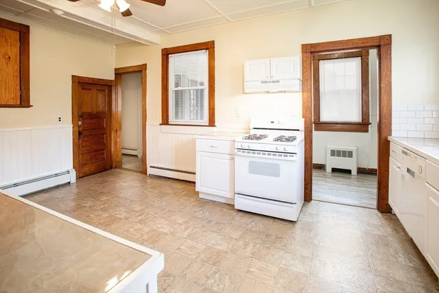 a view of a kitchen with wooden floor and electronic appliances