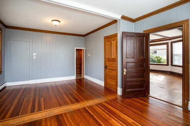 wooden floor in an empty room with a window