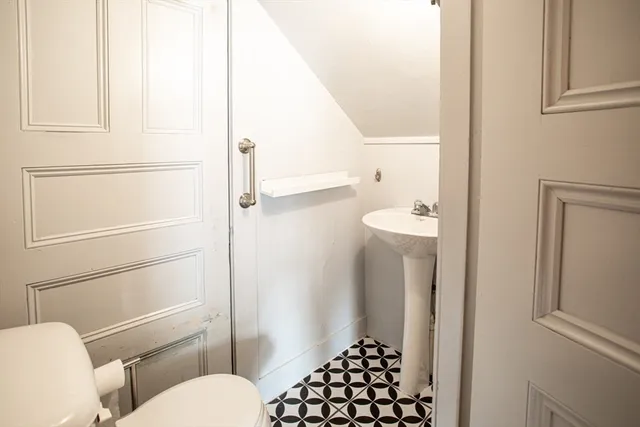 a bathroom with a toilet and a shower