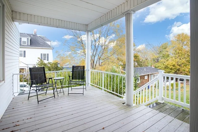 a view of a balcony with chairs