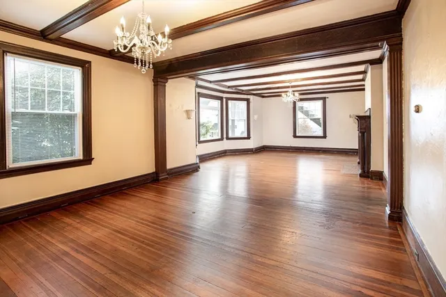 a view of livingroom with window wooden floor and chandelier