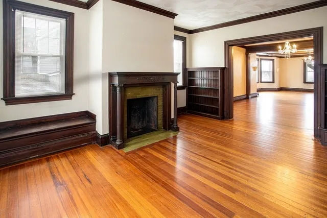 a living room with wooden floors and a fireplace
