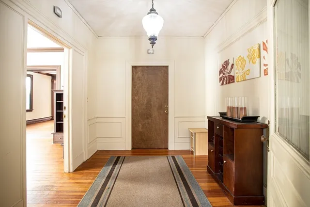 a view of a hallway view with wooden floor and staircase