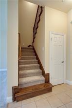 4679 Edith Street Plano, TX 75024 - Photo 20 of 34 Carpeted staircase featuring a dark wood handrail and wainscoting